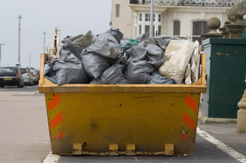 Clean-up crew managing waste at a commercial site in Feltham