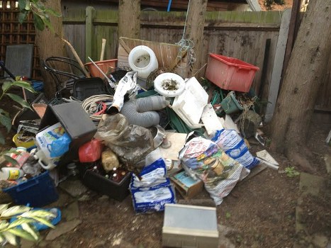 Workers segregating different types of construction waste at a Feltham site